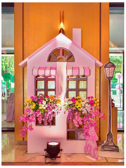 A charming Parisian house facade prop, with flower boxes overflowing with colourful blooms, adding to the romantic city theme.