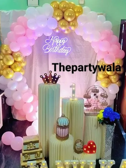 Another beautiful pink and gold balloon arch, this time with a simpler arrangement of pedestals. It shows how the same concept can be adapted for different spaces and budgets.