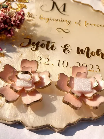 A close-up of the custom rose ring holders, which are a unique and romantic way to display your rings.