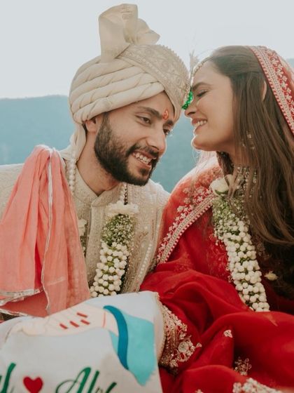 Another joyful moment from the Rishikesh wedding. This close-up shows the couple's happiness and the bride's effortlessly beautiful makeup that looks radiant in the natural sunlight.