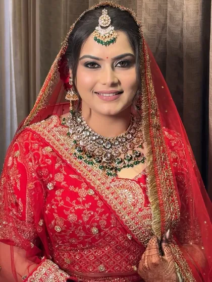 A bride's smile is the final touch. For Jagriti's wedding day, I created a classic look with flawless airbrush makeup, defined eyes, and a bold red bindi to match her stunning lehenga. Her happy, confident expression says it all.
