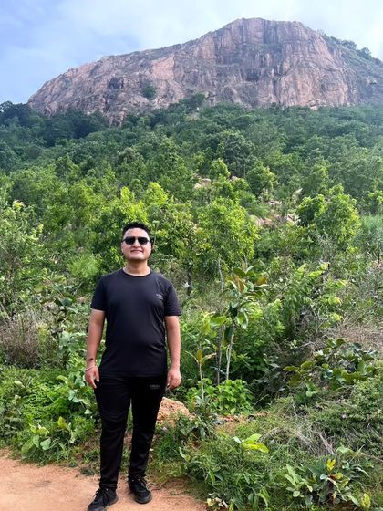 Standing before the mighty Makalidurga hill. This photo shows the scale of the trek that awaits.