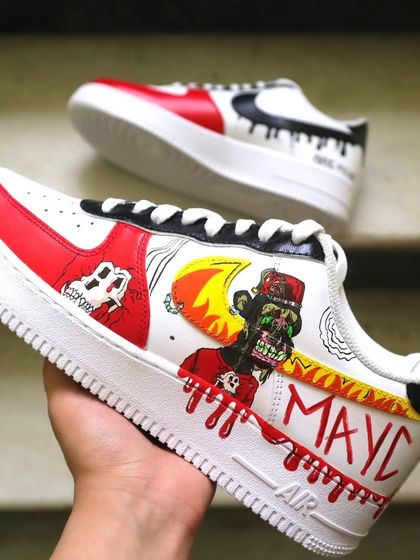 Holding up the finished MAYC NFT sneaker. This design is a great example of how I can take digital art and translate it into a piece of wearable, hand-painted fashion.