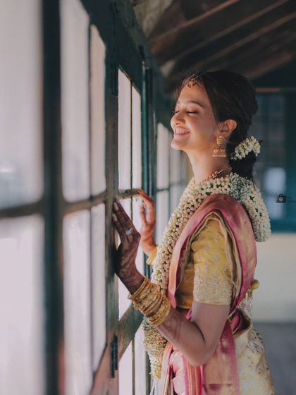 The bride, Shubra, enjoying a quiet moment of happiness by the window before her ceremony.