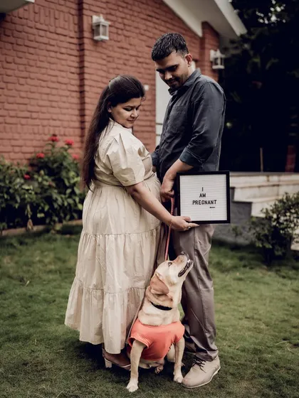 Our furry friends are family too. Including your pet in your maternity shoot can add a wonderful layer of personality and joy. This shot perfectly captures the excitement of the whole family, paws and all, for the new arrival.