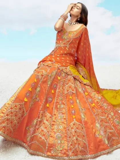 A dramatic and beautiful shot showcasing the full, wide flare of the orange lehenga skirt. The intricate embroidery and tassel details add to its festive charm.