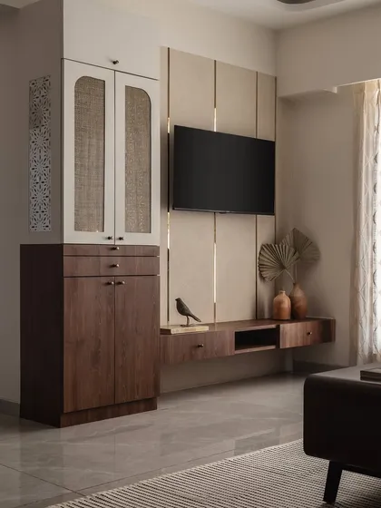 This entertainment zone combines functionality with style. The floating TV console provides storage without taking up floor space, and the combination of wood, rattan, and textured wall panels adds warmth and visual interest.