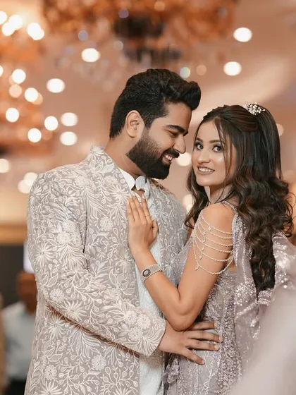 A candid shot from an engagement party, showing the couple sharing a happy, intimate glance. This photo captures the joy and excitement of starting a new chapter together, set against the elegant backdrop of the celebration.