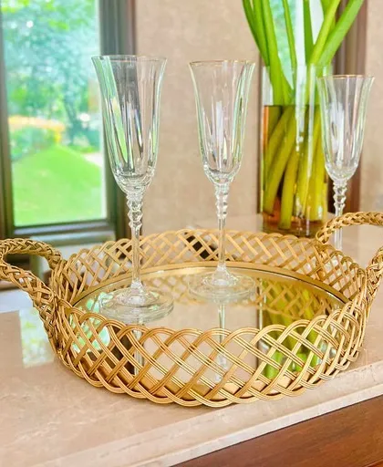 This close-up shot highlights the handcrafted jail work and braided handles of our gold mirror tray. It's a piece that combines traditional craftsmanship with luxurious appeal, perfect for any stylish home.