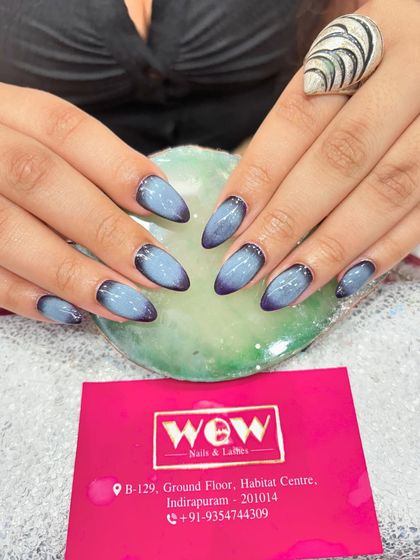 A moody and beautiful aura nail design. This look features a deep purple to light blue gradient, creating a soft, airbrushed effect that is both trendy and unique.