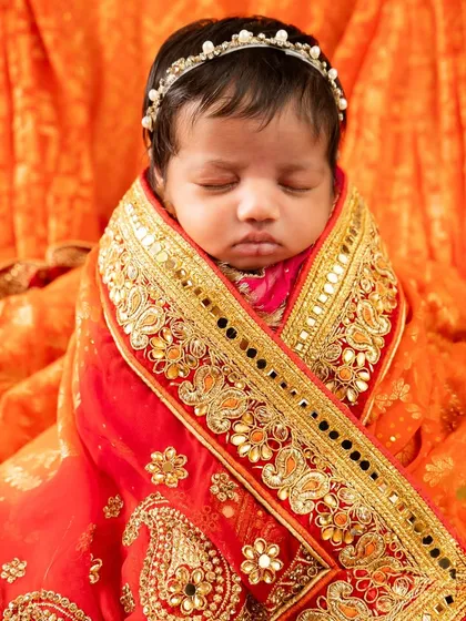 A deeply personal portrait of an 18-day-old baby girl wrapped in her mother's ornate orange and gold wedding saree. I love incorporating family heirlooms into my sessions.