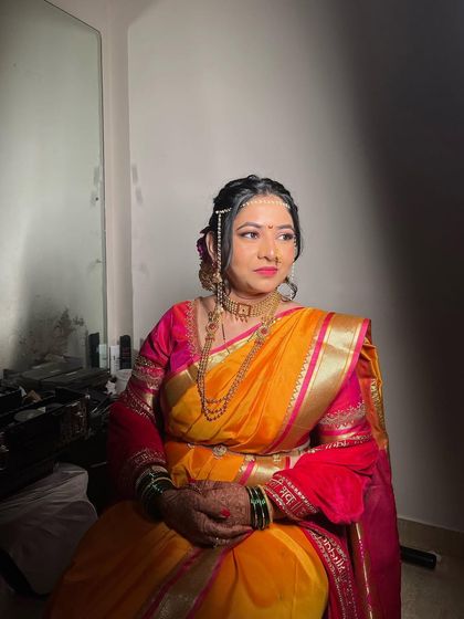 A profile shot showing the details of the traditional jewelry and soft makeup for this Vidhi look.