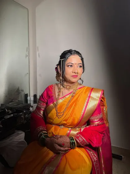 A profile shot showing the details of the traditional jewelry and soft makeup for this Vidhi look.