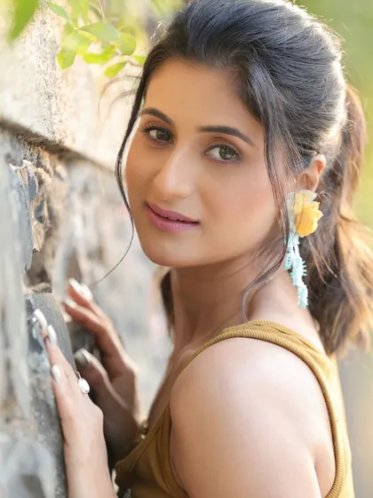 A soft and gentle close-up of Shiwani Chakraborty. This natural light portrait highlights her delicate features and provides a gentle contrast to her more stylized looks.
