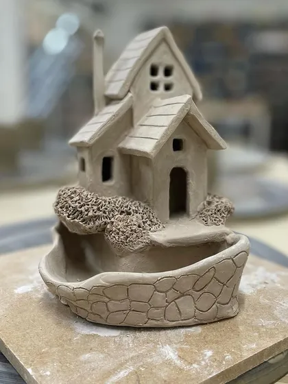 An imaginative incense holder in the shape of a house, crafted using various hand-building techniques.