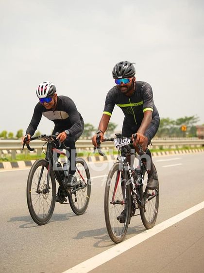 Two riders from the masters category, working together in a breakaway.