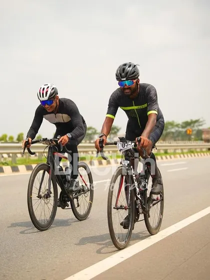 Two riders from the masters category, working together in a breakaway.