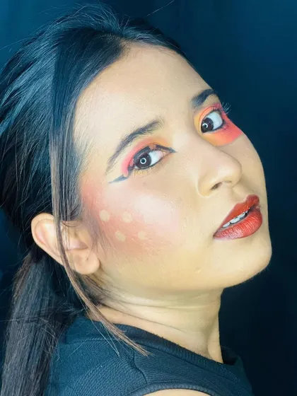 A profile shot highlighting the sharp wing of the eyeliner and the soft diffusion of blush dots on the cheek, complementing the abstract eye makeup.