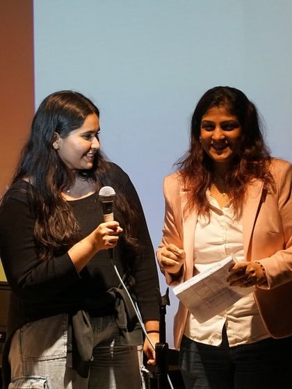 A teacher congratulates a student on stage at the Thane recital. Our educators are mentors who guide and support students through their entire performance journey, from practice to the final bow.