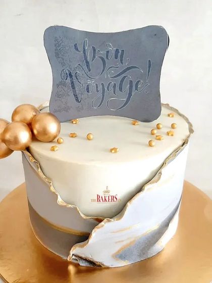 A beautiful Bon Voyage cake for someone embarking on a new journey. This gluten-free rich chocolate cake has an elegant grey and gold marble fault line design.