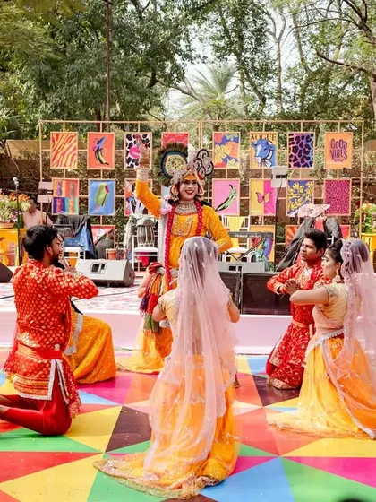Another angle of the Radha-Krishna performance, showcasing the vibrant costumes and the unique stage backdrop.