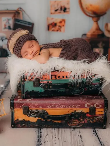 A full view of the little explorer's setup, complete with a globe, camera, and vintage props. I love creating these imaginative worlds for my tiniest clients.