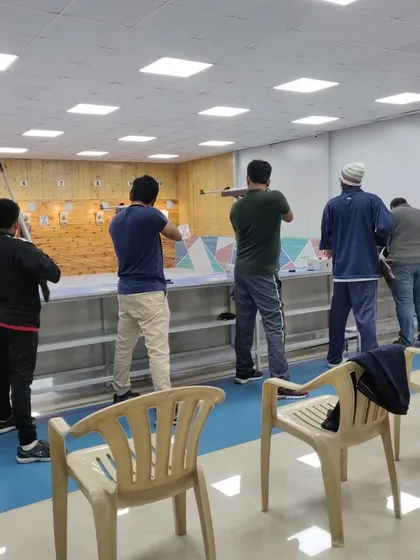 Students participating in a friendly match at the academy. These internal competitions are designed to simulate a real tournament environment, helping shooters manage match pressure.