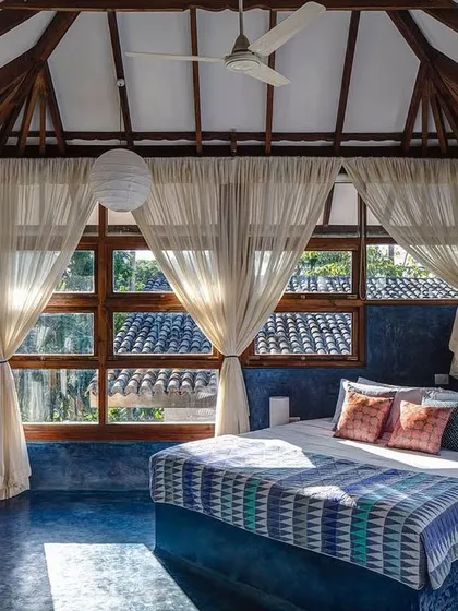 The Sky Room at Jalakara, designed as an elevated pavilion to be at the tree canopy level. The seamless blue floor and large windows create a light-filled, airy retreat that immerses you in the surrounding nature.