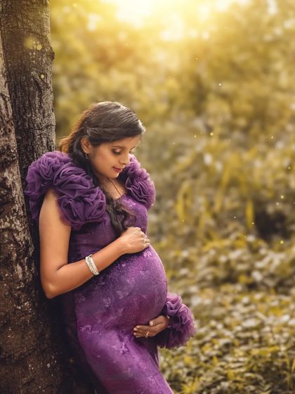 A quiet, contemplative pose against a tree. The golden sunlight filtering through the leaves creates a magical, warm glow in this beautiful outdoor portrait.