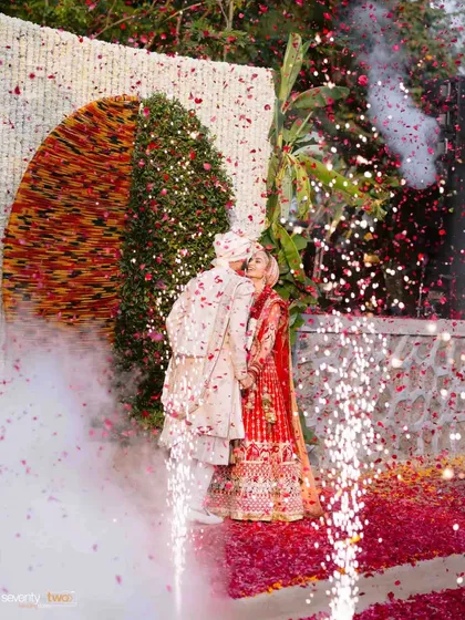 A kiss amidst fireworks and a shower of petals, a truly explosive and passionate moment captured perfectly.