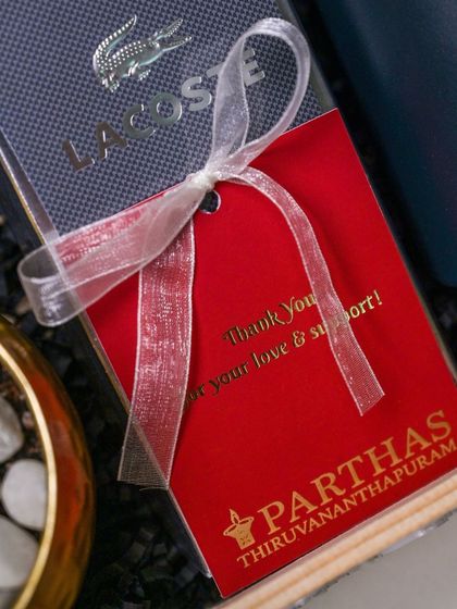 A close-up of a luxury corporate gift for Parthas Thiruvananthapuram, showing a branded thank you tag tied with a delicate ribbon.