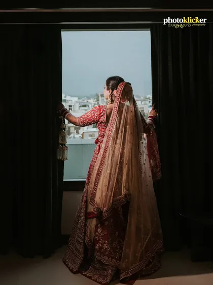 A thoughtful portrait of the bride looking out the window before her ceremony, capturing a moment of quiet anticipation.