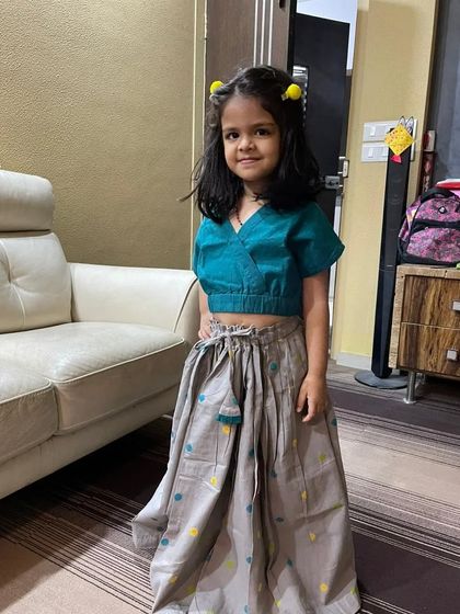 Little Riva looks so sweet in our Handloom Polka Ghagra Choli. The breathable cotton fabric and easy-to-wear silhouette make it a great choice for long wedding celebrations where comfort is key.