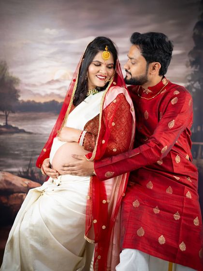 A beautiful portrait celebrating tradition. This couple is dressed in classic Indian attire, sharing a loving moment that honors their cultural heritage during their maternity journey.
