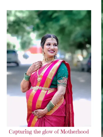 The elegance of tradition. This solo portrait from a baby shower shoot highlights the beauty of the mother-to-be in her vibrant saree and the joy of the occasion.