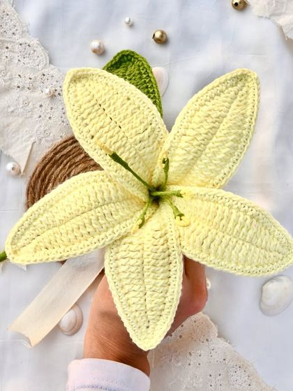 A single, elegant crochet lily in a soft yellow color. Perfect for adding a touch of grace to any vase or as a standalone gift.