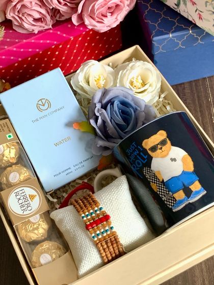 A cool and modern Rakhi hamper for your brother. This box features a Marks & Spencer coffee mug, a Man Company perfume, Ferrero Rocher, and a stylish beaded rakhi.