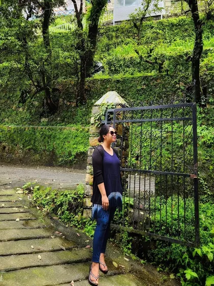 A quiet moment in the lush greenery of Mussoorie. A layered, casual look is perfect for the unpredictable weather of the hill station.