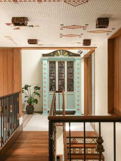 This custom bar cabinet was designed as a centerpiece for a landing. Inspired by Chettinad architecture, it features stained glass panels and a playful colour palette of mint green and ochre, making it a joyful and nostalgic statement piece.