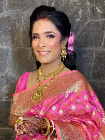A close-up of my beautiful Bengali bride. The pink eyeshadow and rosy blush give her a fresh, youthful glow that is perfect for her reception celebration.