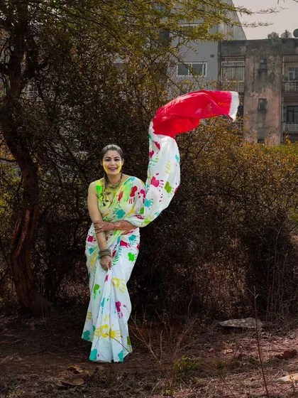 Capturing the beautiful drape of the saree as it catches the wind. This shot from the Holi series is full of movement and grace, highlighting the festive outfit in a natural setting.