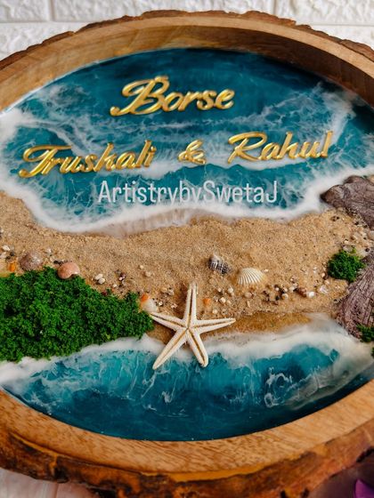 The golden acrylic names stand out beautifully against the deep blue of the resin ocean. This piece is fully personalized for the Borse family.