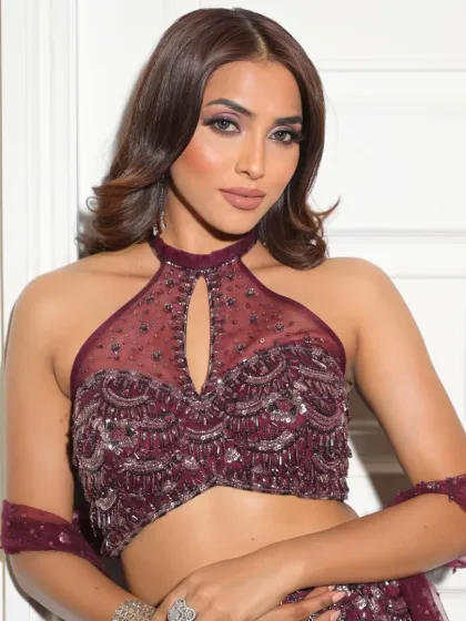 A close-up that highlights the sharp, defined eye makeup and the flawless skin. It's a look that is both bold and beautiful.