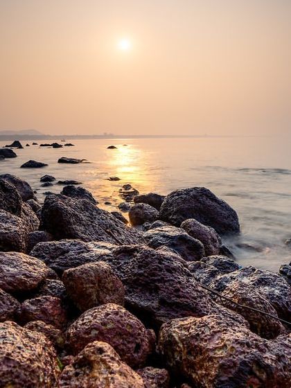 The sun rises over the rocky coast of South Goa. Using a slow shutter speed, I captured the movement of the water as it flowed around the rocks, adding a sense of motion to the tranquil scene.