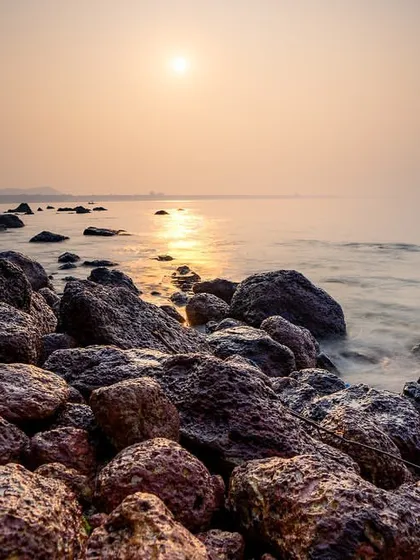 The sun rises over the rocky coast of South Goa. Using a slow shutter speed, I captured the movement of the water as it flowed around the rocks, adding a sense of motion to the tranquil scene.