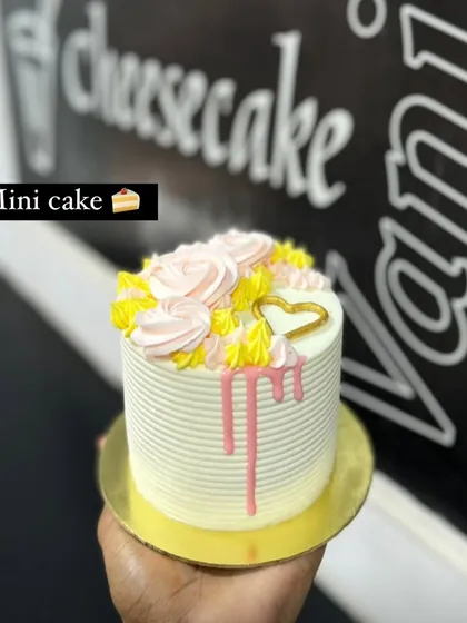 A hand-held view of the mini cake, showing its petite and personal size.