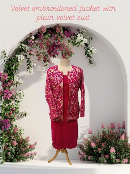 This ensemble features a richly embroidered velvet jacket layered over a plain velvet suit. It's a luxurious and coordinated look, perfect for winter weddings.