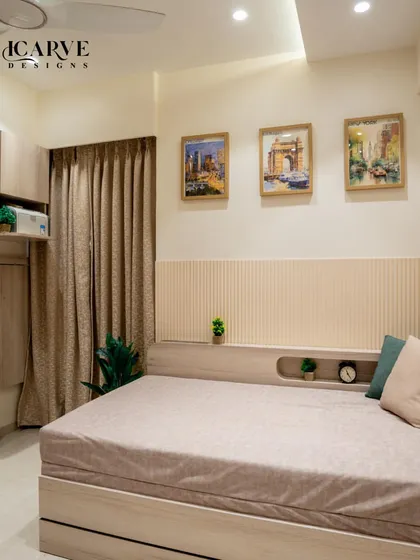This cozy bedroom features a bed with a built-in headboard shelf, perfect for keeping books, a clock, and small plants. The vertical paneling adds texture and visual interest to the wall.