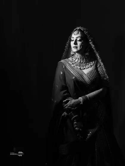 There is a timeless elegance to black and white photography. This moody, artistic bridal portrait uses shadows and light to create a powerful and emotive image that feels like a piece of classic cinema.