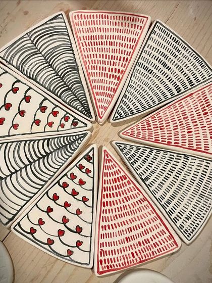 These hand-painted triangular plates were part of a special collection. I love experimenting with geometric patterns and playful designs like these hearts and lines.